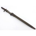 A bayonet in a leather scabbard, dated 1918,