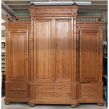A housemaid's large Continental breakfront cupboard, the side wings with galleried tops,