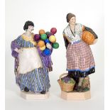 A Dulwich pottery figure, a lady with a pumpkin under her arm and a basket of grapes at her feet,