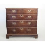 A large George III oak chest of two short and three long drawers, on bracket feet,