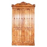 A mid 19th Century maple wood linen press, with shaped arch cornice,