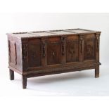 An oak chest, with quadruple panel hinged cover,