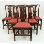 Six fruitwood dining chairs of late 18th Century design, with pierced upright splat to the backs,