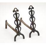 A pair of Arts and Crafts bronze andirons with stylised spandrels,