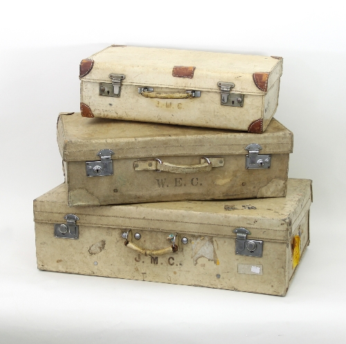 Three white leather suitcases