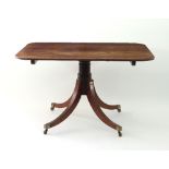 A Regency mahogany breakfast table with rectangular tilt-top and four outsplayed legs,