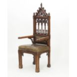 A Victorian gothic grained oak armchair,