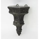 A Victorian gothic pewter wall bracket with frieze of grapes and trailing vines and gothic arch