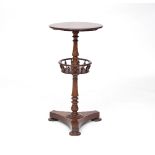 A Victorian rosewood sewing table with circular top and turned stem with basket, on a triform base,