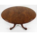 A Victorian figured walnut oval table, raised on a turned and carved column and quadruple support,