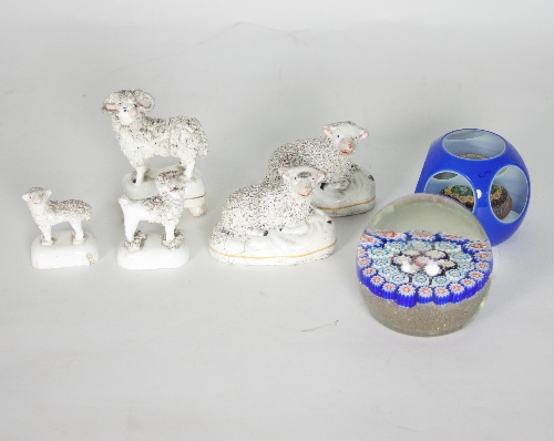 Five various Staffordshire figures of sheep and two glass paperweights with millefiori centres