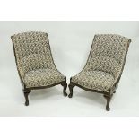 A pair of nursing chairs, each with scroll beech frames with gilt metal flowerhead terminations,