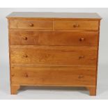 A Shaker cherry wood chest of drawers of two short and three long on bracket feet,