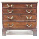 A Regency mahogany chest of four graduated drawers with brass swing handles, on shaped bracket feet,