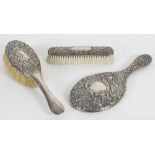 A silver backed clothes brush, HM, Birmingham 1898, a silver backed hand mirror, MW,