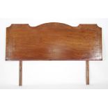 A 19th Century mahogany headboard with brass stringing and shaped top,