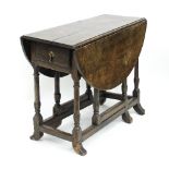 A 19th Century oak oval two-flap gateleg table fitted a drawer,