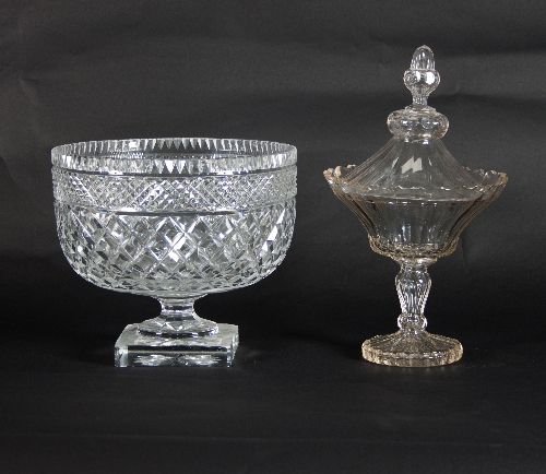 A cut glass confiture and cover with pointed finial and serrated border, raised on a pedestal base,