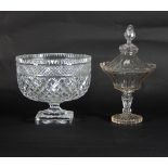 A cut glass confiture and cover with pointed finial and serrated border, raised on a pedestal base,