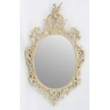 A carved limewood and painted rococo mirror,