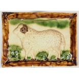 A Scottish lead-glazed earthenware plaque, moulded in relief with a ram in a pastoral setting,