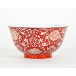 A Chinese bowl, decorated chrysanthemums and scrolling foliage on a red ground,