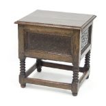 An oak box top chest with hinged cover and carved panels to the front and sides,