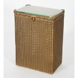 A Lloyd Loom 'Lusty' laundry basket/side table painted in gold with fitted glass top,