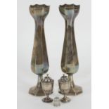 A pair of octagonal tulip shaped silver vases, EHL & S, Birmingham 1905 and a pair of pepper pots,