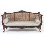 A Louis XV style walnut and caned canape, circa 1880,