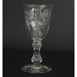 A glass ale goblet, the bowl etched hops and barley,