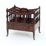 A 19th Century mahogany Canterbury with five divisions and handle above a drawer on turned legs