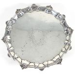 A George II silver salver, William Peaston, London 1750, with pie crust edge on scroll feet,