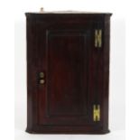 An early George III mahogany corner cabinet,