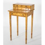 A Regency satinwood work table with ebony stringing,