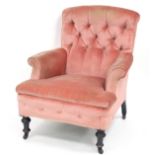 A Victorian armchair with deep button back, upholstered seat and arms,