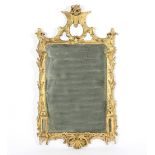 A George III carved and gilded wall mirror, the surmount carved with scrolls and a rose flowerhead,