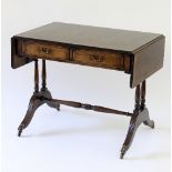 A reproduction sofa table, fitted two drawers opposed by two dummy drawers,