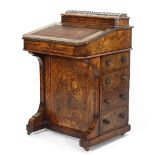 A mid Victorian figured walnut Davenport, with hinged stationery compartment to the back,