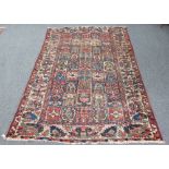 A Kurdish carpet with central field of forty-five rectangular geometric panels within a