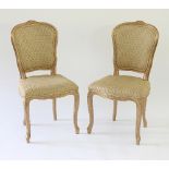 A pair of salon chairs with gold frames,