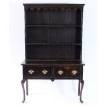 An 18th Century style oak dresser with shaped frieze,