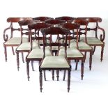 A closely matched set of ten Victorian mahogany dining chairs with carved bar backs,