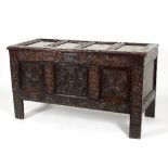 An early 18th Century oak chest with quadruple panelled top,