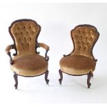 A pair of Victorian walnut framed fireside chairs,