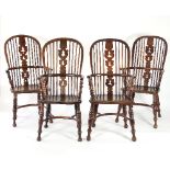 A closely matched set of four Windsor splat back armchairs, one in yew wood,