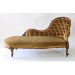 A Victorian walnut framed chaise longue, the upholstered button back with carved legs on castors,