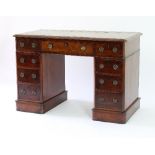 A lady's mid 19th Century mahogany and walnut pedestal desk, with tooled green leather inset top,