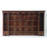 A fine 18th Century oak dresser rack with shaped frieze on quarter column supports and three