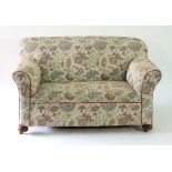 A Victorian two-seater sofa with drop down arm, on bun feet,